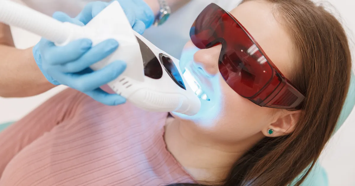 Woman receiving professional teeth whitening treatment in a dental chair at P&E Dental.